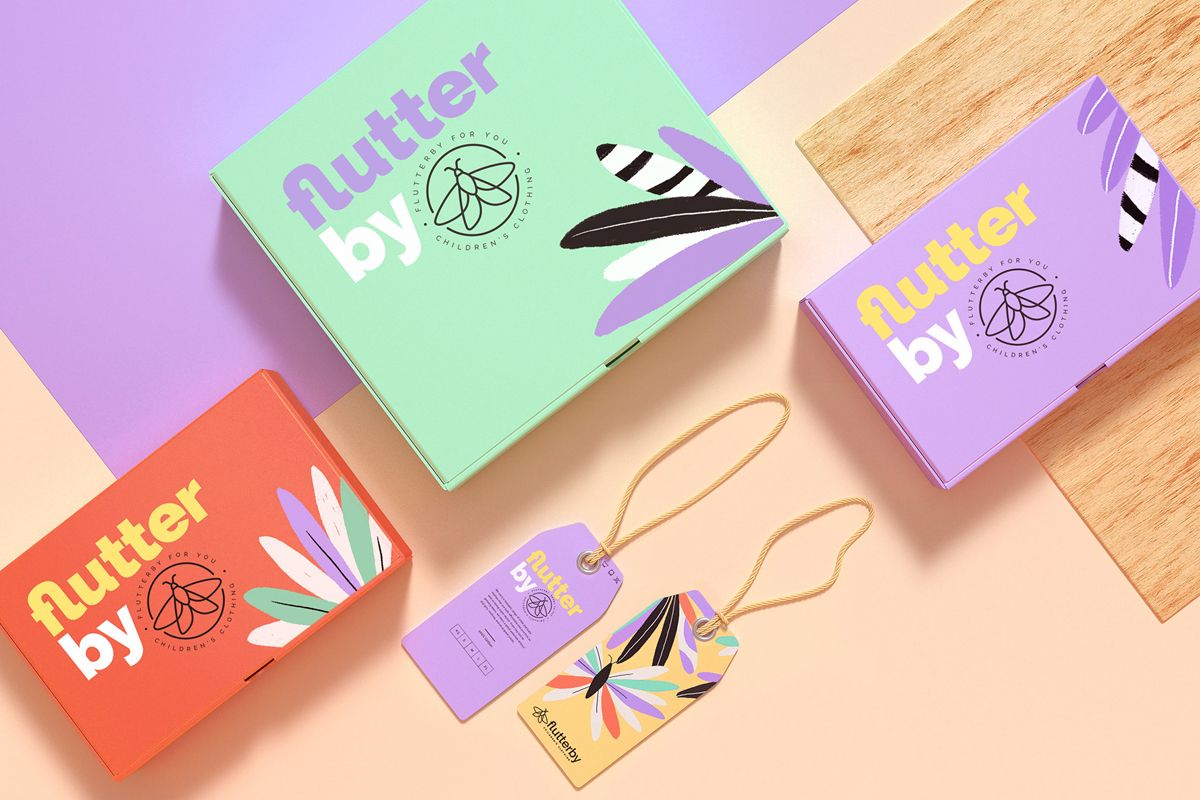 Top view of three boxes and two hang tags with a clothing packaging design applied.