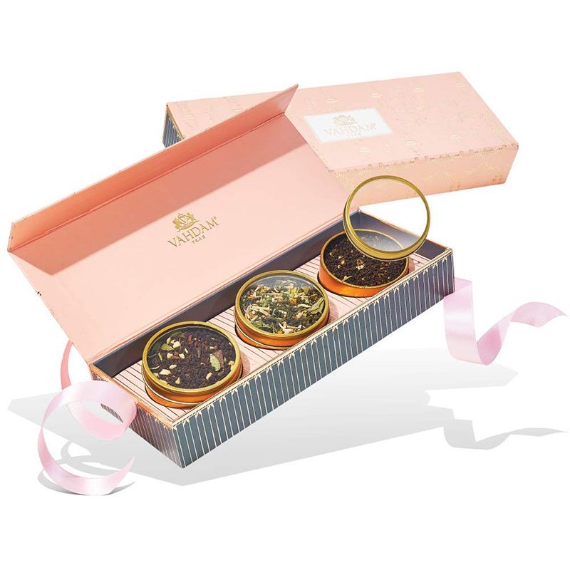 Valentine’s Day packaging for a set of three tea flavors, one packaging box with an opened lid showing the three teas inside and the other box with a closed lid behind it. Soft pink color with gold foiling details give this box luxurious look.